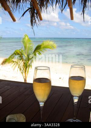 6 maggio 2005; Aitutaki, Isole Cook; l'isola di Aitutaki è un volo di 45 minuti a nord di Rarotonga, l'isola principale delle Isole Cook nel cuore del Pacifico meridionale. Aitutaki è un'isola laguna, con colline ondulate, villaggi pittoreschi e la maggior parte delle sistemazioni turistiche. L'isola è circondata da una barriera corallina e fiancheggiata da una ventina di piccole isole coralline disabitate. Sono queste isole che hanno il fascino più turistico, con splendide spiagge orlate da palme e eccellenti lagune per lo snorkeling. Nella foto: La vista da un bungalow sulla spiaggia dell'Etu Moana Villas in Foto Stock