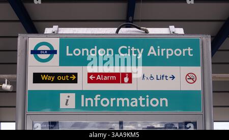 Londra, Regno Unito - 13 novembre 2024: Un cartello per London City Airport, che indica anche servizi come informazioni, uscita, allarme, ascensore. Logo o Foto Stock