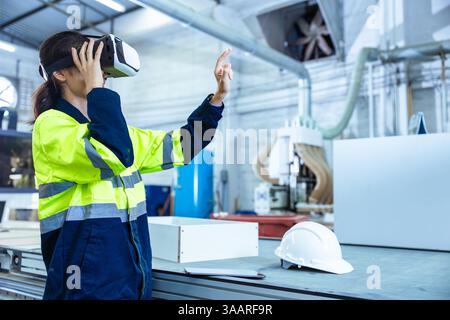 Modern Factory Innovation Technology in Industry, Technician female using VR Virtual Reality Headset in Wood Furniture Design workshop. Foto Stock