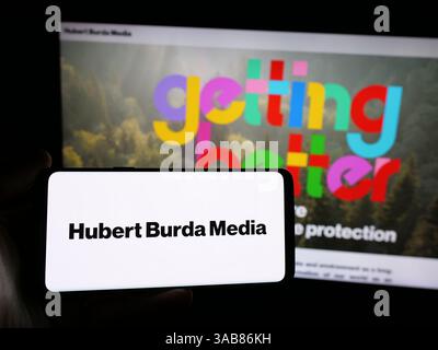 Germania. 7 marzo 2025. In questa immagine, una persona ha in mano uno smartphone con il logo dell'azienda tedesca Hubert Burda Media che tiene KG sullo schermo davanti al sito Web aziendale. (Immagine di credito: © Timon Schneider/SOPA Images via ZUMA Press Wire) SOLO PER USO EDITORIALE! Non per USO commerciale! Foto Stock