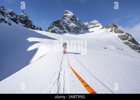 Scialpinismo con corda, team di corda sul ghiacciaio Vadret da Porchabella sulla salita alla vetta del Piz Kesch, paesaggio montano in inverno, alpino a. Foto Stock