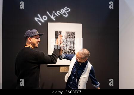 New York, New York, Stati Uniti. 3 aprile 2025. Artexpo New York, che dura fino al 6 aprile, ha aperto al Pier 39 sul Lower East Side, con gallerie e artisti che mostrano arte contemporanea a un pubblico impegnato. Il fotografo Nabil West è un visitatore giusto di fronte alla sua fotografia della marcia delle donne del 2017 sulla 42nd Street di New York. Crediti: Ed Lefkowicz/Alamy Live News Foto Stock