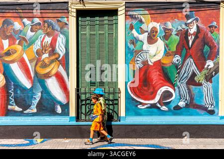 Due ragazzi passano davanti A Una casa colorata nel quartiere Barrio Sur di Montevideo, Uruguay. Foto Stock
