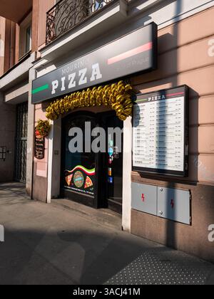 Praga, Repubblica Ceca - 25 marzo 2025: Ristorante con pizza Mourino a praga, cechia, decorato con palloncini d'oro, che presenta il suo menu e. Foto Stock