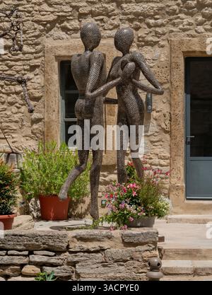 Due figure di dadi umani danzanti di fronte a una casa vista nel sud della Francia Foto Stock