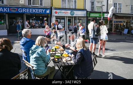 Brighton Regno Unito 6 aprile 2025 - i visitatori godono di una colazione al caffè mentre migliaia di corridori prendono parte alla Maratona di Brighton oggi in una calda giornata di sole : Credit Simon Dack / Alamy Live News Foto Stock