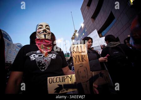 22 novembre 2011 - Los Angeles, California, Stati Uniti - i manifestanti hanno tenuto dei cartelli e indossato una maschera durante una manifestazione "Occupy" fuori dalla Federal Reserve Bank. (Immagine di credito: © Mark Samala/ZUMAPRESS.com) Foto Stock