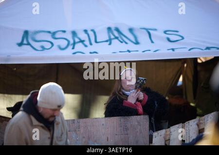 23 novembre 2011 - Toronto, Ontario, Canada - 12:00 - Un protestatore ripugnante documenta la polizia dall'interno di una tenda fortificata. Le tensioni continuano ad aumentare mentre la polizia di Toronto forma una linea fuori dalla cattedrale di St. James per consentire ai membri dell'unità di pubblica sicurezza della polizia di entrare e rimuovere diversi manifestanti che hanno continuato a resistere all'azione della polizia. (Immagine di credito: © Chris Drost/ZUMAPRESS.com) Foto Stock