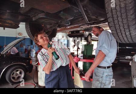 SP.92222.- - CONSEGNA A:.FLORIDIAN.- -.9/22/1999.- -.ST.PE.DIDASCALIA INFO:. Caroline J. Spencer proprietaria controlla una trasmissione con il meccanico Tony Gray. Garage Caroline Spencer & Wilsey a St. Petersburg. Possiede e gestisce un garage fondato da suo nonno e suo padre. Esercitazione pratica su boss, assegnazioni e controlli dei lavori in corso. Inoltre, gareggia con la sua Porsche e gestisce i clienti. Inoltre. Gareggia con la sua Porsche in Autocrass a McDill, altrove. Trofei gara in garage. E mostra i gatti premio con premi da mostrare. Possiamo fotografarla controllando i motori delle auto, anche con la Porsche a casa o in garage? Nella sala d'attesa nic Foto Stock