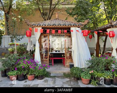 Un pittoresco gazebo cinese, splendidamente decorato con lanterne rosse e bandiere. Foto Stock