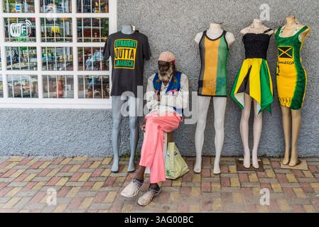 Ocho Rios, Giamaica - 9 aprile 2024: Vista diurna sulla strada di Ocho Rios, negozio e venditore seduti nel negozio in Giamaica. Foto Stock