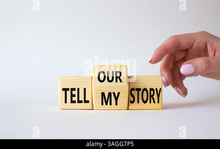 Raccontate il nostro simbolo o la mia storia. L'uomo d'affari punta i cubi di legno con parole che raccontano la mia storia e raccontano la nostra storia. Splendido sfondo bianco. Affari Foto Stock