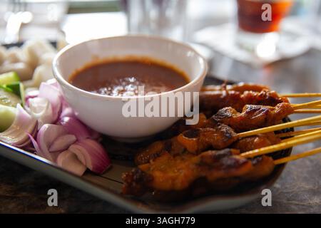Pollo satay con salsa alle arachidi e complementi Foto Stock