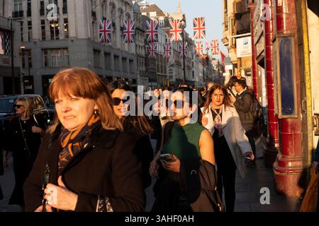Gli amanti dello shopping in una trafficata Oxford Street durante l'ora di punta di fine giornata mentre turisti e lavoratori si affollano lungo la strada, Londra, Inghilterra, Regno Unito Foto Stock