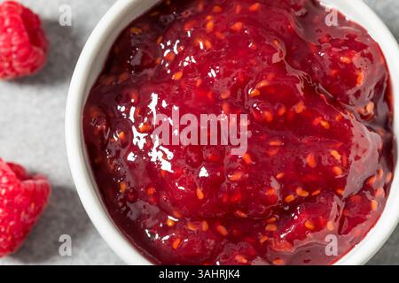 Sweet Organic Red Raspberry Preserves Jam in a Bowl Stock Photo