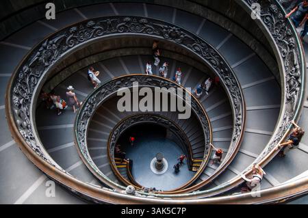 Visitatori che esplorano la scala a chiocciola del Bramante nei Musei Vaticani a Roma, Italia Foto Stock