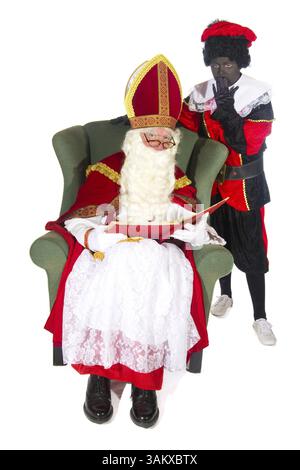Sinterklaas e Nero Piet lettura nel libro rosso Foto Stock