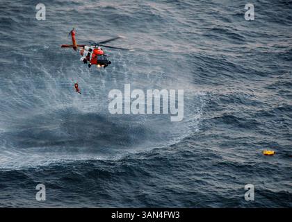 21 aprile 2010 - Kodiak, Alaska, Stati Uniti - l'equipaggio di un elicottero MH-60 Jayhawk con base a Kodiak recupera il nuotatore di salvataggio dopo aver salvato con successo quattro membri dell'equipaggio di Northern Belle da una zattera sganciata dall'equipaggio di un aereo HC-130 Hercules dalla stazione aerea di Kodiak, il campo di detriti e l'acqua 50 miglia a sud di Monatgue Island. L'equipaggio di Northern Belle ha emesso una chiamata di sindaco e ha abbandonato la nave di 75 piedi con base a Seattle nelle acque fredde del Golfo dell'Alaska poco dopo le 17:30 (immagine di credito: © Petty Officer 1st Class Sara Francis/U.S. Guardia costiera/ZUMApress.com) Foto Stock
