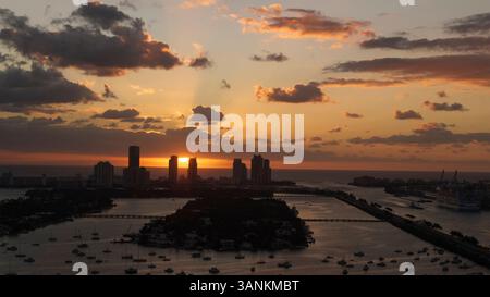 Vista aerea dell'alba sullo skyline di Miami Beach con nuvole e riflessi sull'acqua, Watson Island, Stati Uniti. Foto Stock
