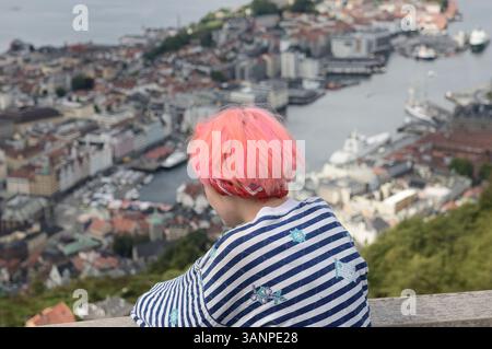 Una giovane donna turistica che guarda la città. Bergen vista dal Monte Floyen nella contea di Vestland sulla costa occidentale della Norvegia. Foto Stock