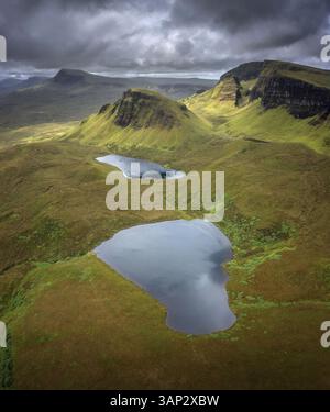 Vista aerea del suggestivo paesaggio di Quiraing con maestose montagne, lago tranquillo e aspra valle, Portree, Scozia. Foto Stock