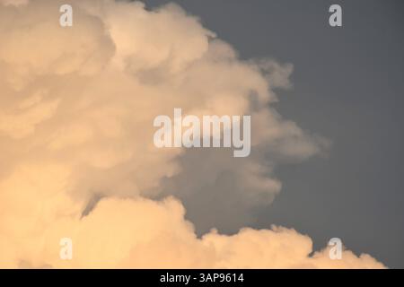 nuvole bianche e scure che galleggiano sul cielo dopo la pioggia che cade di sera Foto Stock