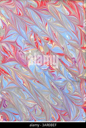 Carta marmorizzata a mano con motivo a freccia diagonale in rosso, viola, blu e nero Foto Stock