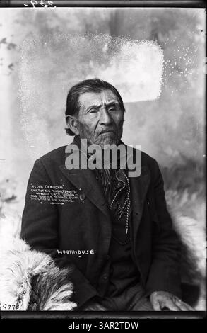 Fotografia di Lee Moorhouse della collezione University of Oregon Libraries, raffigurante Peter Coquilton, un indiano Yakima e capo dei Muckleshoots, vestito con insegne tradizionali. L'immagine cattura una figura importante nella leadership dei nativi americani. Foto Stock
