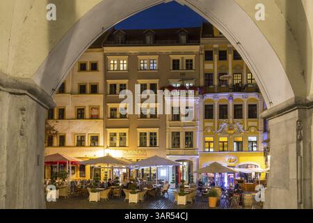 Vista attraverso gli archi dei portici della sala che ospita la fila di caffè di strada di notte, Untermarkt Goerlitz, Sassonia, Germania, Europa Foto Stock