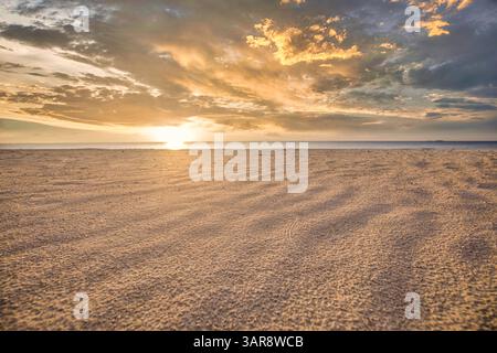 Rilassante spiaggia tropicale con onde soffici tramonti, luce del sole dorata e nuvole pastello all'orizzonte, tranquillo paesaggio marino estivo all'aperto pareti artistiche Foto Stock