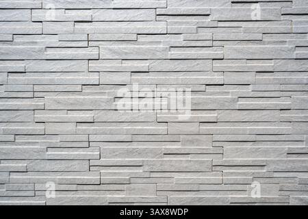Sfondo di un muro di piastrelle di pietra bianca Foto Stock