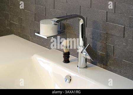 Rubinetto del bagno e spazzola per la rasatura Foto Stock