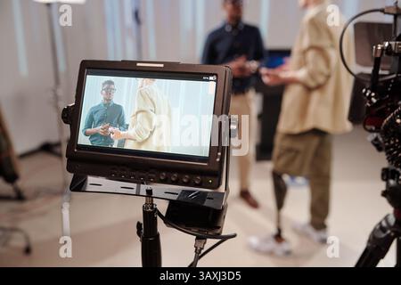 Cameraman e uomo d'affari africano in mostra di fotocamera durante la discussione Foto Stock