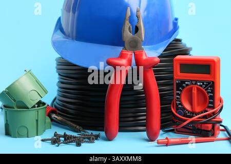 Set di diverse forniture per elettricisti su sfondo a colori Foto Stock