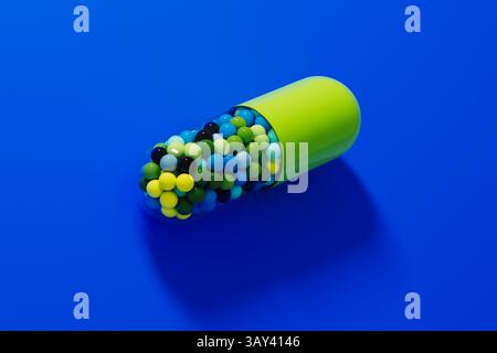Una vivace pillola di capsule mostra una serie di tavolette colorate, creando una grafica sorprendente su uno sfondo blu brillante. Foto Stock