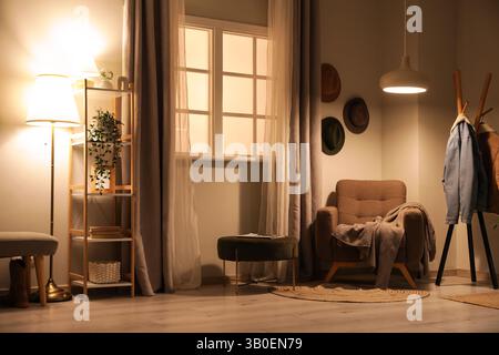 Scaffale, poltrona e lampada a incandescenza all'interno del corridoio Foto Stock