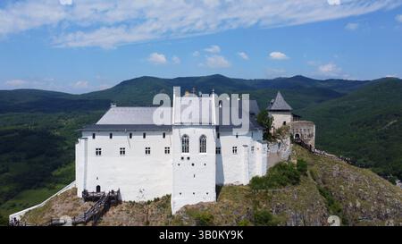 Il castello medievale ungherese si erge sulla cima della montagna. Panorama panoramico e vista panoramica. Foreste e valli verdeggianti, fortezza storica. Foto Stock