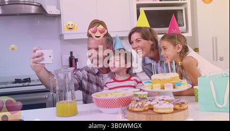 Immagine di emoticon sulla felice famiglia caucasica durante la festa di compleanno facendo selfie Foto Stock