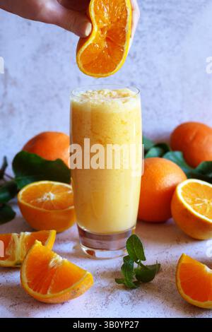 Frullato salutare per colazione con succo d'arancia fresco e latte di cocco Foto Stock