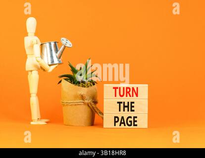 Ruotare il simbolo della pagina. Le parole chiave girano la pagina su un bellissimo blocco di legno. Modello da uomo d'affari. Bellissimo sfondo arancione. Motivazione aziendale Foto Stock