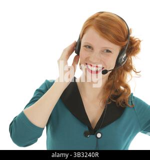 Giovane donna dai capelli rossi con testa per call center Foto Stock