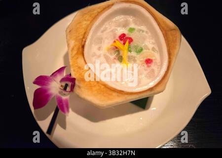 30 novembre 2015 - Bangkok, Thailandia - tipico piatto di dessert tailandese. Jackfruit al latte di cocco. Ristorante, hotel, Shangri la, Bangkok, Thailandia, Asia. Salathip si trova in prossimità di New Road su Soi Wat Suan Phlu e si trova all'interno dello Shangri-la Hotel, Bangkok. Serve piatti tradizionali e classici nelle acque fluenti del fiume Chao Phraya, il "fiume dei re". Sale massaggi, mercati notturni e molti piatti thailandesi, che riassumono la tua esperienza nella grande città di Bangkok. Gli amanti del cibo come me sicuramente presteranno più attenzione agli aspetti culinari della città (e naturalmente allo shopping – ma quale Foto Stock