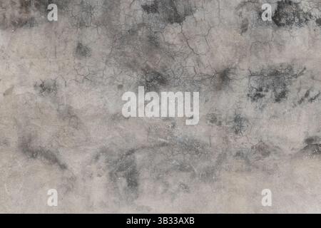 Immagine ad alta risoluzione di una superficie in cemento intemprato che mostra crepe e motivi naturali, ideale per sfondi, trame o elementi di design requ Foto Stock