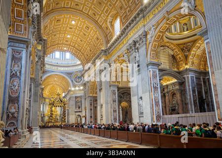 Città del Vaticano, Vaticano - 25 aprile 2025: I fedeli si allineano per rendere omaggio al corpo di Papa Francesco esposto nella bara al centro della Basilica di San Pietro. Foto Stock