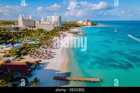 Scopri le viste mozzafiato di Palm Beach ad Aruba, dove le morbide sabbie bianche si incontrano con le acque cristalline turchesi. Foto Stock