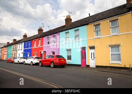 La "Rainbow Square" di Gloucester, con case dai colori vivaci, su Nettleton Road, St Kilda Parade e Station Road, creata dall'artista Tash Frootko. - 1 ma Foto Stock