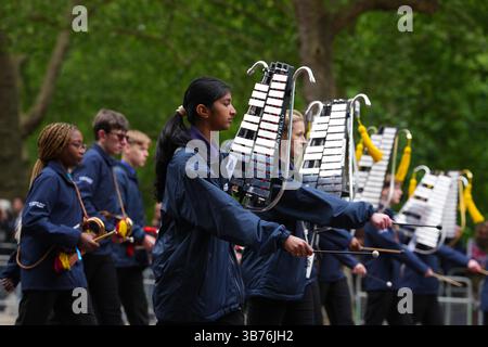 Membri delle forze armate cadetti e giovani in uniforme insieme a musicisti della Band of the Boys' and Girls' Brigade sfilano sul Mall durante una processione militare in occasione del 80° anniversario del VE Day, e in onore di coloro che hanno prestato servizio durante la seconda guerra mondiale, nel centro di Londra. Data foto: Lunedì 5 maggio 2025. Foto Stock