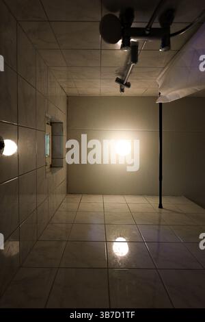 Spazio interno moderno e pulito, con una sala ben illuminata e elementi di design funzionali. L'immagine mostra un corridoio minimalista e un'area bagno Foto Stock