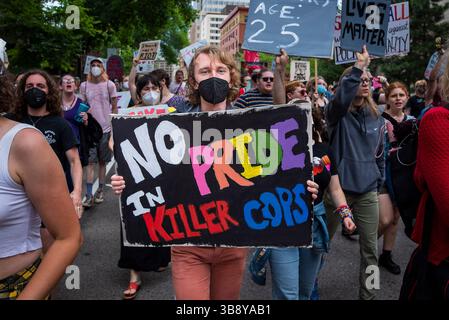 25 giugno 2023, Minneapolis, Minnesota, Stati Uniti: Un manifestante porta un cartello con scritto "No Pride in Killer Cops". In risposta all'influenza aziendale e della polizia sulla celebrazione del Twin Cities Pride, la Take Back Pride Coalition organizzò la sua protesta annuale. Il gruppo marciò lungo Hennepin Avenue e terminò a Loring Park. Foto Stock
