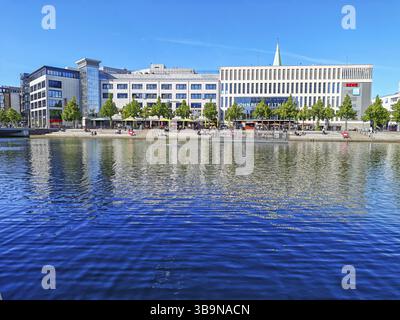 Vista sul porto delle barche, negozi e ristoranti a più piani del centro città, negozi, nuovi edifici, architettura, riflessi sull'acqua, promenad Foto Stock